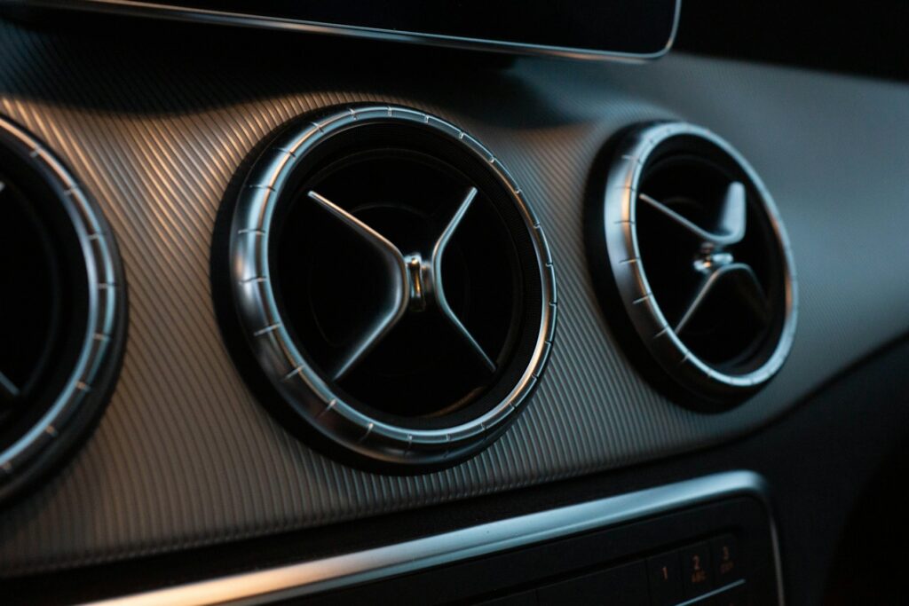 Round air-conditioning vents on a car dashboard
