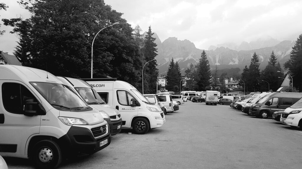 Rows of white vans in a car park